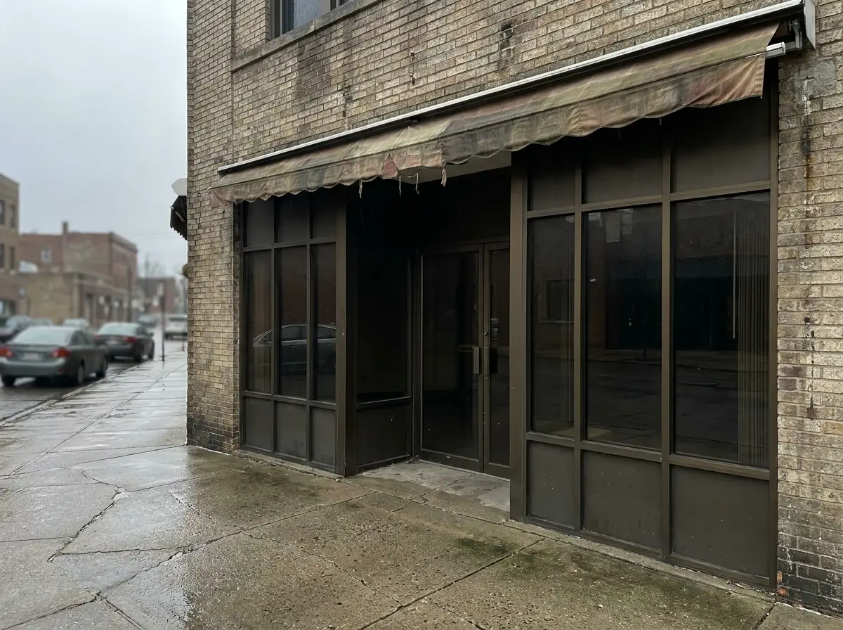 Parkway Plaza before reglaze — dated bronze storefront